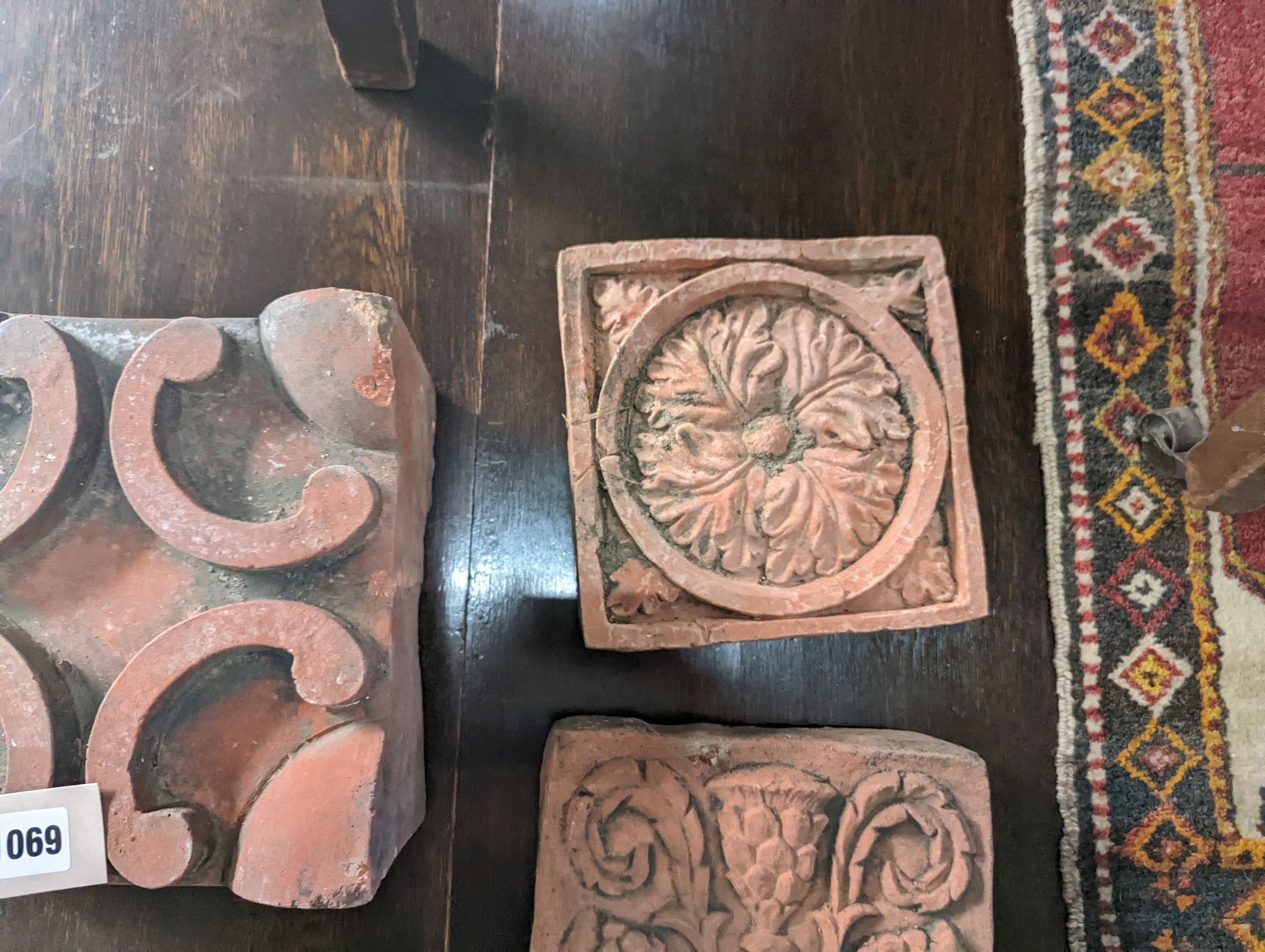 Five square terracotta garden tiles, largest width 22cm, depth 14cm